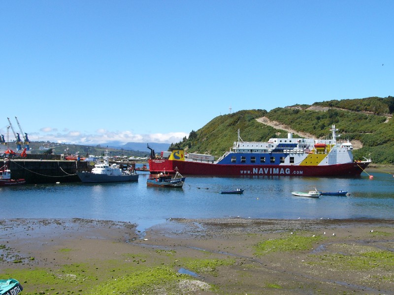 P1080766.JPG - The Navimag ferry prior to us boarding it at Puerto Montt. Approximately 220 passengers boarded it on this day. Most were headed for the eventual destination of Puerto Natales after 3 nights on board. The boat also made a brief stop at Puerto Eden -a small hamlet located in Welllington Island in Ultima Esperanza (Last Hope) province, Magallanes region. It is one of Chile's most isolated inhabited places together with Easter Island and Villa Las Estrellas with a population of only 175 people. The ferry just stops and a handful of people are helped onto dinghies for transportation to shore and a handful get on