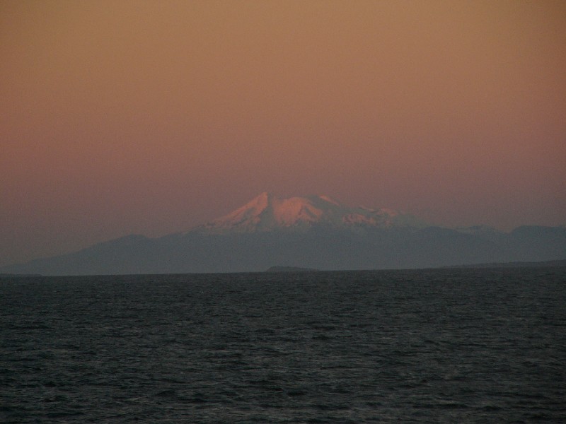 P1080803.JPG - 8 pm: Parting shot on Day 1 minutes before darkness, looking east at the Michinmahuida volcano.  Much closer to the Gulf is the Volcanic Caldera Chaitén (not seen in the picture) which erupted in May 2008 requiring the nearby town of Chaitén to be evacuated. More at http://en.wikipedia.org/wiki/Chait%C3%A9n_(volcano)