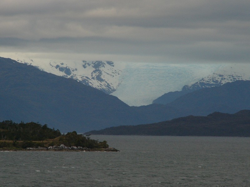 P1080888.JPG - Day 3: 5:45 pm: The detour. Despite being several hours behind schedule, the ferry turned north after crossing Grappler Channel to pay a visit to Glacier Pio XI that hangs off the Campo de Hielo Sur (Southern Patagonian Ice field). The glacier is seen in this picture from a distance.